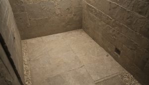 Is a dark limestone shower threshold normal wetting or a construction defect destination and access reference